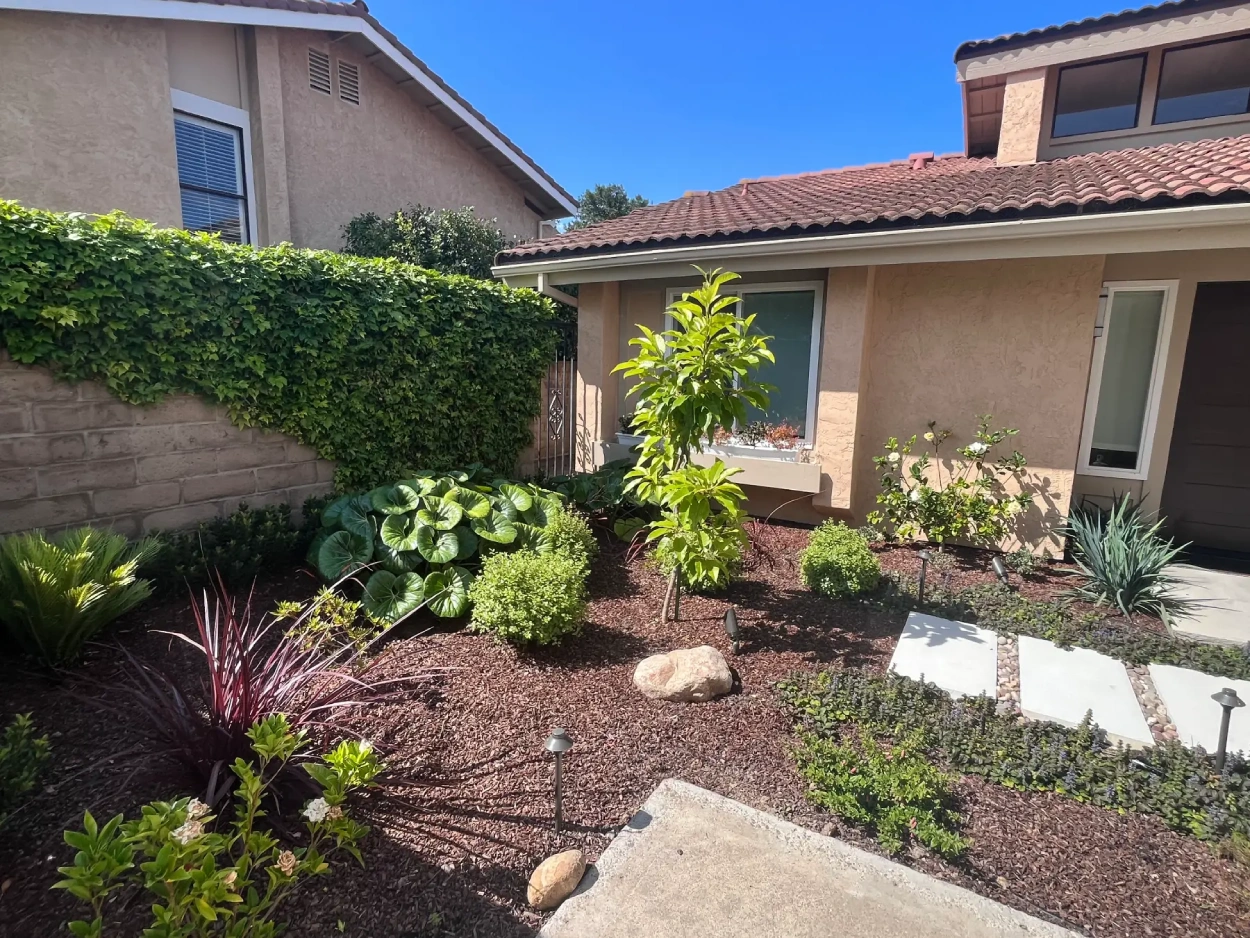 Completed La Jolla backyard with precast concrete stepping stones, shade sails, and outdoor lighting