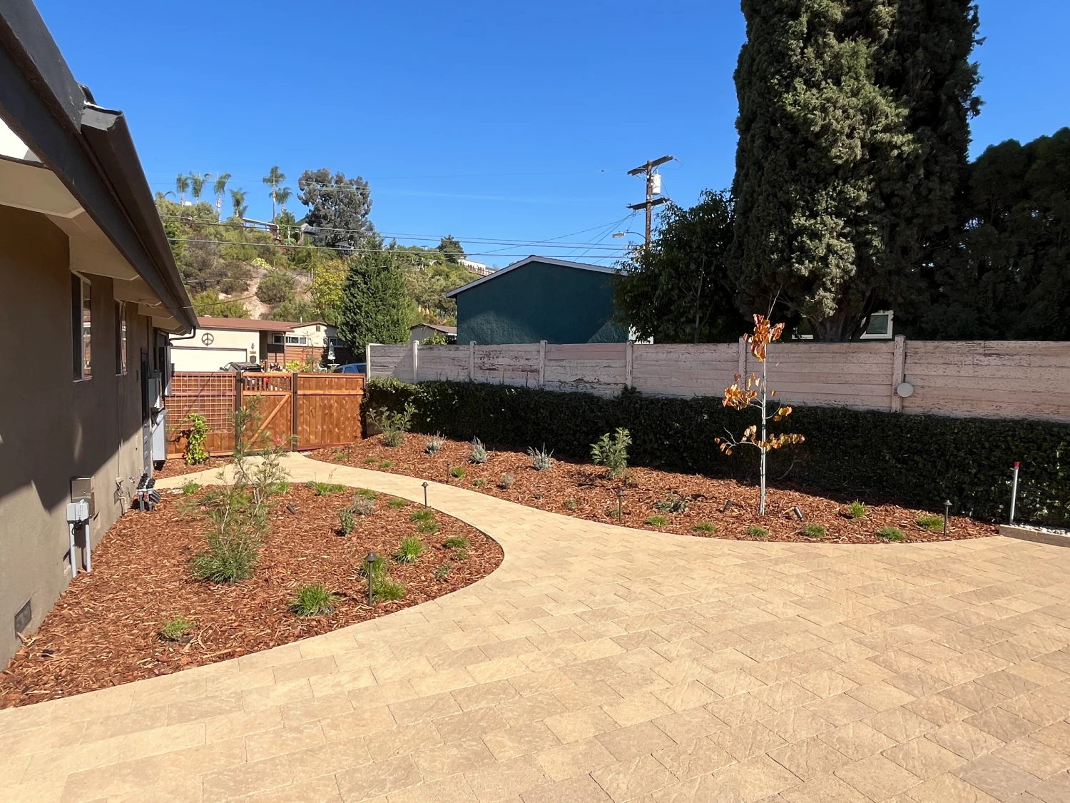 Full view of paver patio with custom craftsman-style fencing.