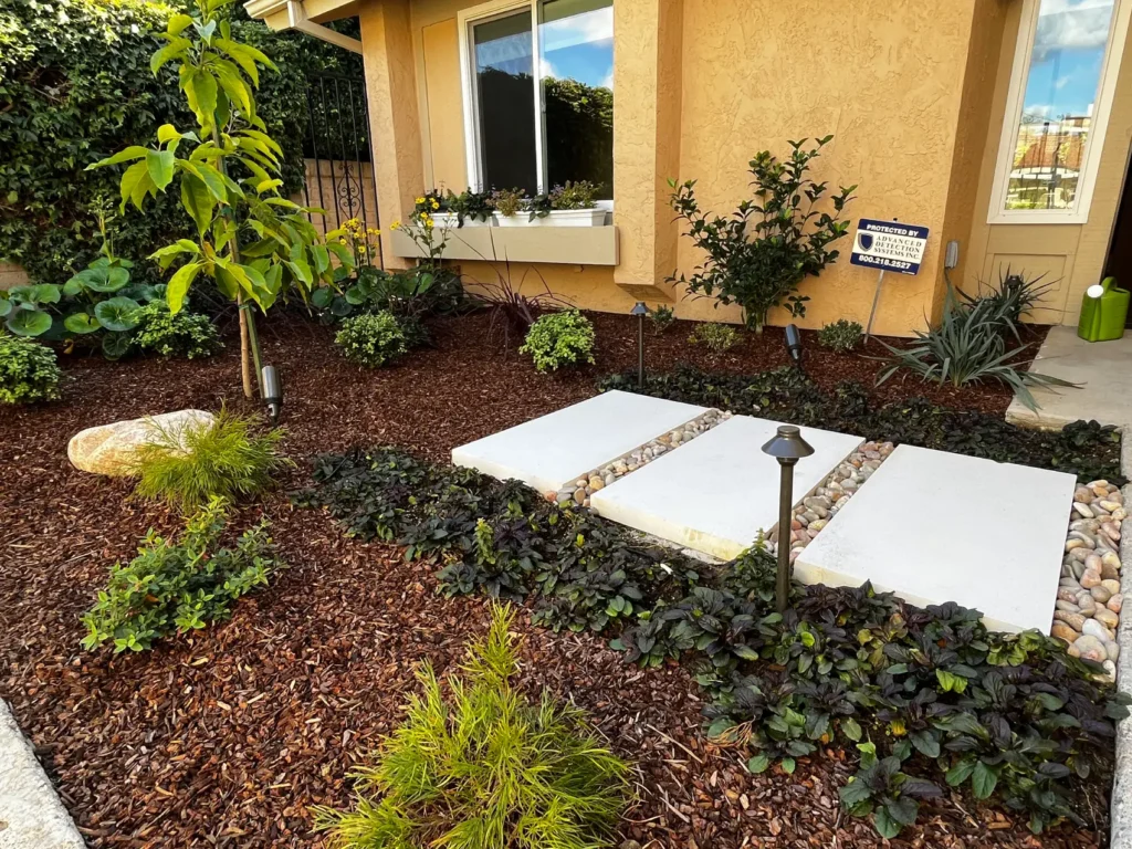 Finished La Jolla backyard with infinity canopy shade sail, precast concrete stepping stones, and landscape lighting by Botanically Crafted Landscapes, San Diego